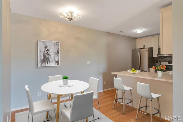 1316 Holgate Dr Unit G5, Ballwin, MO 63021 - dining room featuring light wood-type flooring and baseboards