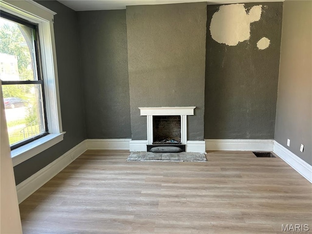 4844 Northland Ave, Saint Louis, MO 63113 - unfurnished living room featuring wood finished floors, baseboards, and a fireplace