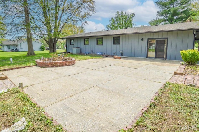 19 Ruth Ann Dr, Godfrey, IL 62035 - back of property featuring board and batten siding, a patio, and a yard