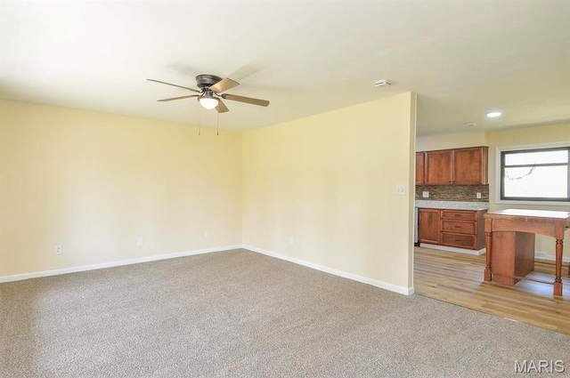 19 Ruth Ann Dr, Godfrey, IL 62035 - unfurnished living room featuring light carpet, a ceiling fan, baseboards, and recessed lighting
