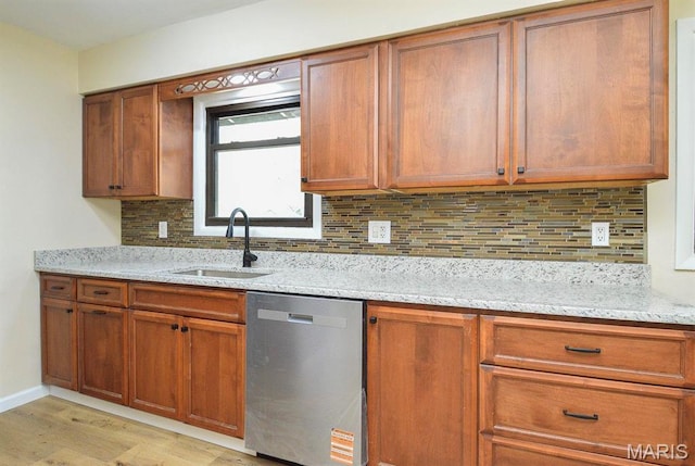 19 Ruth Ann Dr, Godfrey, IL 62035 - kitchen featuring dishwasher, a sink, light wood-type flooring, light stone countertops, and brown cabinetry