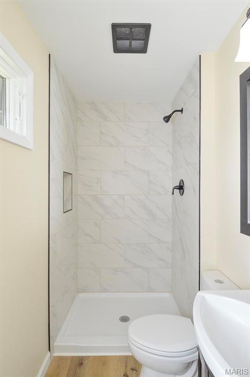 19 Ruth Ann Dr, Godfrey, IL 62035 - bathroom featuring a sink, toilet, a shower stall, and wood finished floors