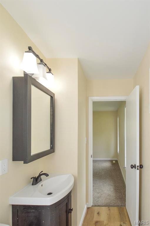 19 Ruth Ann Dr, Godfrey, IL 62035 - bathroom featuring vanity, wood finished floors, and baseboards