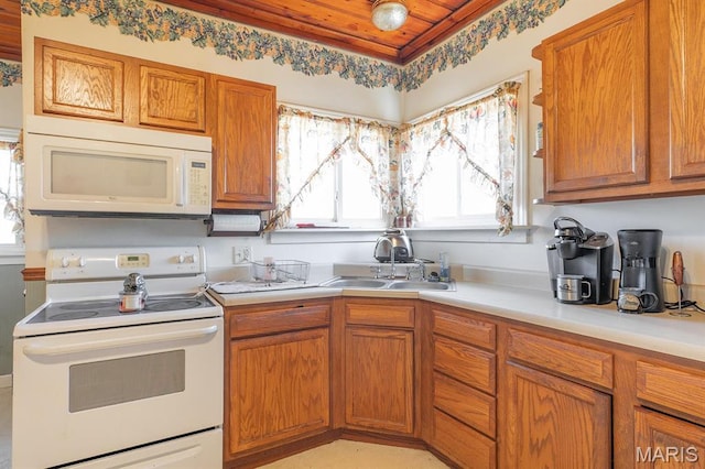 2418 Willow St, Alton, IL 62002 - kitchen featuring white appliances, a sink, light countertops, wood ceiling, and brown cabinetry