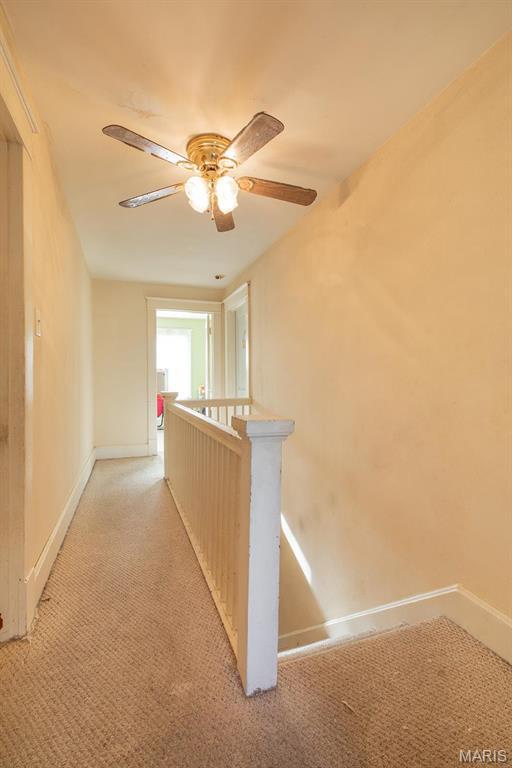 2418 Willow St, Alton, IL 62002 - hallway featuring an upstairs landing, baseboards, and light carpet