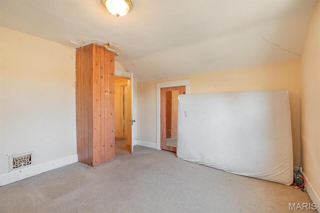 2418 Willow St, Alton, IL 62002 - unfurnished bedroom featuring lofted ceiling, carpet flooring, and baseboards