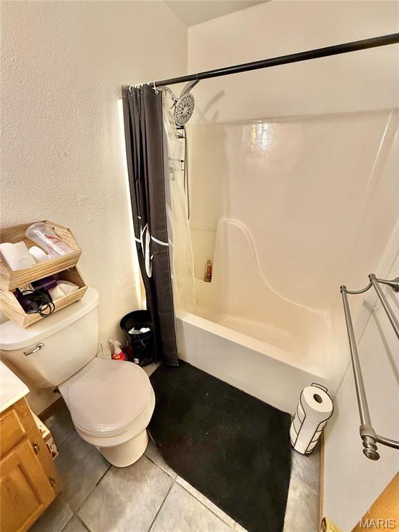 305 Houser St, Park Hills, MO 63601 - bathroom with toilet, shower / bath combination with curtain, tile patterned flooring, vanity, and a textured wall