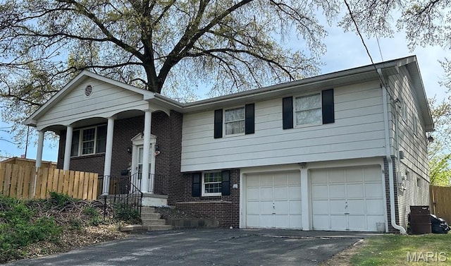 1621 Shurtleff Ct, Alton, IL 62002 - view of front of property with brick siding, fence, a garage, and asphalt driveway