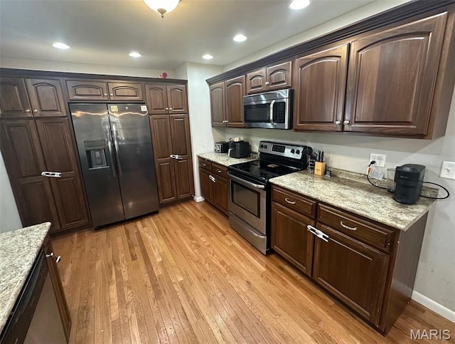 1621 Shurtleff Ct, Alton, IL 62002 - kitchen featuring stainless steel appliances, light wood-type flooring, dark brown cabinetry, light stone countertops, and baseboards