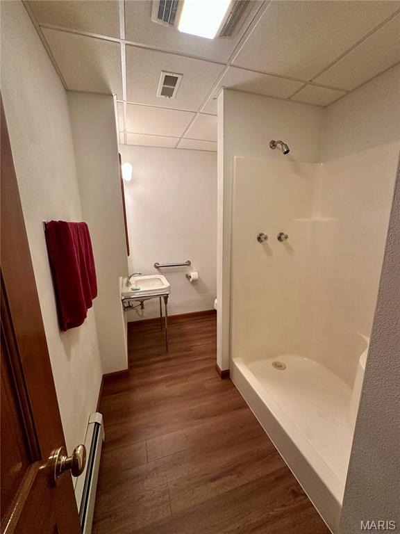 3 Edgewood Acres, Smithton, IL 62285 - full bath featuring a baseboard heating unit, a drop ceiling, a stall shower, wood finished floors, and toilet