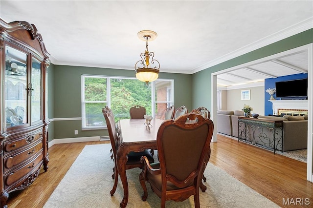 12935 Topping Estates Dr, Town And Country, MO 63131 - dining room with wood finished floors, plenty of natural light, baseboards, ornamental molding, and a brick fireplace