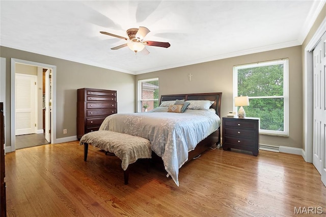 12935 Topping Estates Dr, Town And Country, MO 63131 - bedroom with wood finished floors, ornamental molding, baseboards, ceiling fan, and a baseboard radiator