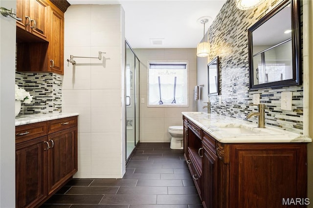 12935 Topping Estates Dr, Town And Country, MO 63131 - bathroom featuring a stall shower, toilet, decorative backsplash, double vanity, and tile walls