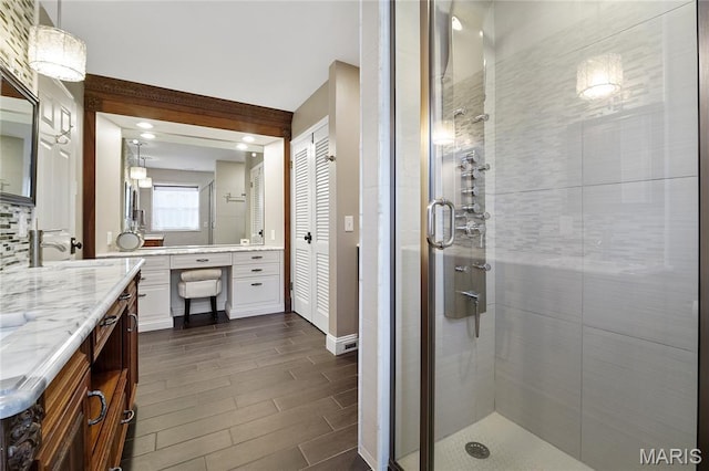 12935 Topping Estates Dr, Town And Country, MO 63131 - bathroom with a shower stall, wood finish floors, and vanity