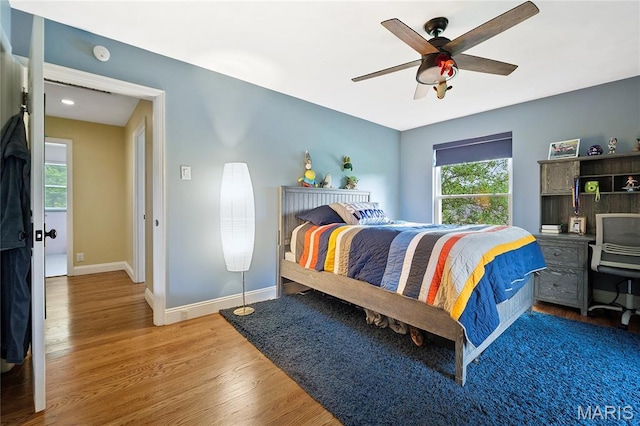 12935 Topping Estates Dr, Town And Country, MO 63131 - bedroom featuring multiple windows, wood finished floors, baseboards, and ceiling fan