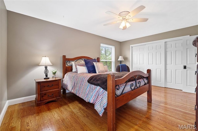 12935 Topping Estates Dr, Town And Country, MO 63131 - bedroom with a closet, baseboards, light wood-style floors, and a ceiling fan