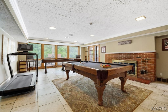 12935 Topping Estates Dr, Town And Country, MO 63131 - recreation room featuring a textured ceiling, a fireplace, tile patterned floors, a tray ceiling, and billiards table