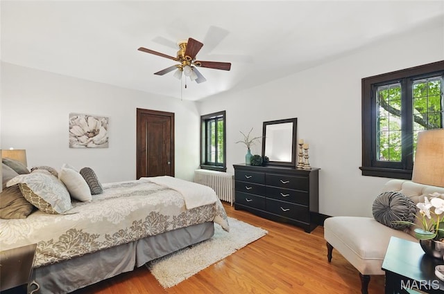 7350 Colgate Ave, University City, MO 63130 - bedroom featuring radiator, multiple windows, and light wood finished floors