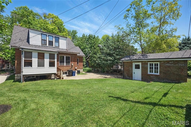 7350 Colgate Ave, University City, MO 63130 - back of property with a yard, brick siding, and a patio