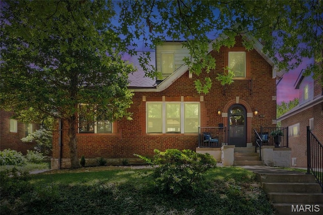 7350 Colgate Ave, University City, MO 63130 - english style home featuring brick siding and a front lawn