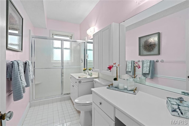 full bathroom with tile patterned floors, a stall shower, toilet, and vanity