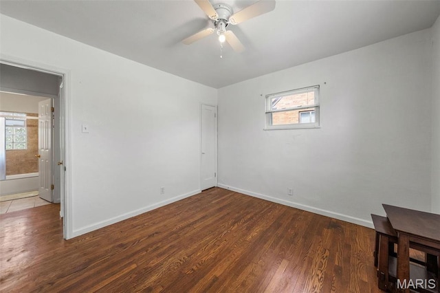 336 Tacoma Dr, Saint Louis, MO 63125 - unfurnished bedroom featuring wood finished floors, multiple windows, and baseboards