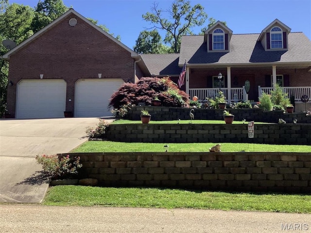 13 Montauk Ct, Leadington, MO 63601 - cape cod home featuring brick siding, concrete driveway, a garage, and a front yard