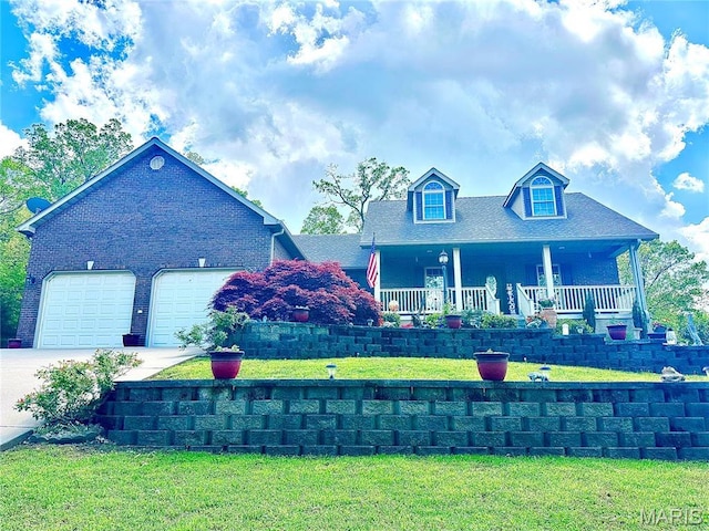 13 Montauk Ct, Leadington, MO 63601 - view of front of property with driveway, a front yard, a porch, a garage, and brick siding