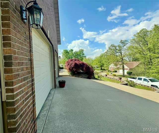 13 Montauk Ct, Leadington, MO 63601 - view of home's exterior with a garage and brick siding
