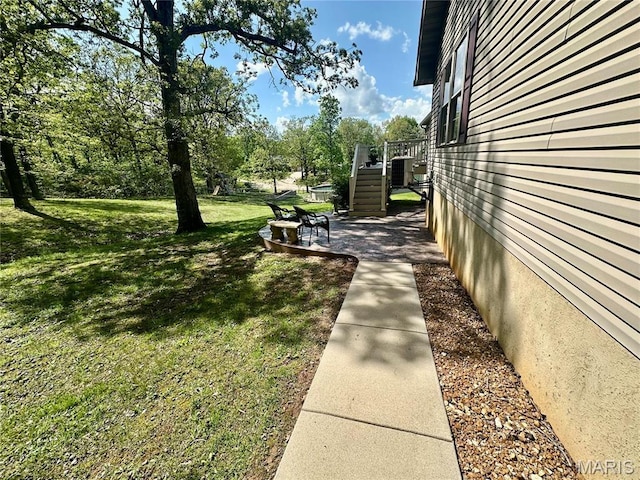 13 Montauk Ct, Leadington, MO 63601 - view of property exterior with a lawn, a patio area, and stairway