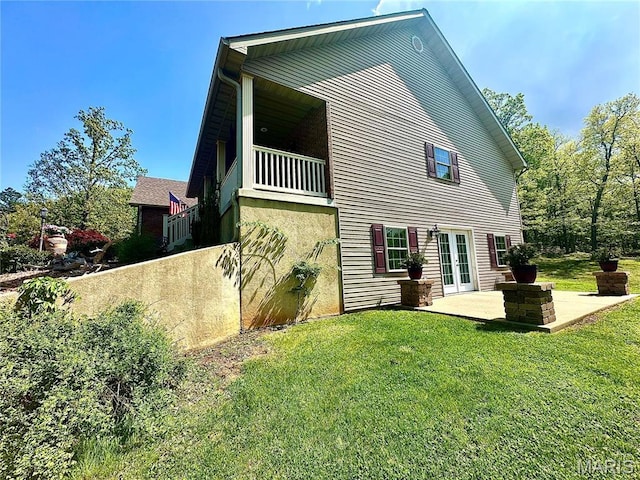 13 Montauk Ct, Leadington, MO 63601 - back of property with french doors, a yard, a patio, and stucco siding