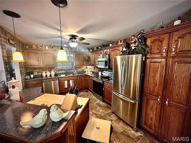 13 Montauk Ct, Leadington, MO 63601 - kitchen with appliances with stainless steel finishes, a sink, ceiling fan, dark countertops, and decorative light fixtures