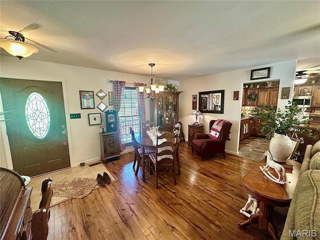 13 Montauk Ct, Leadington, MO 63601 - dining room with a ceiling fan, a chandelier, hardwood / wood-style floors, and baseboards