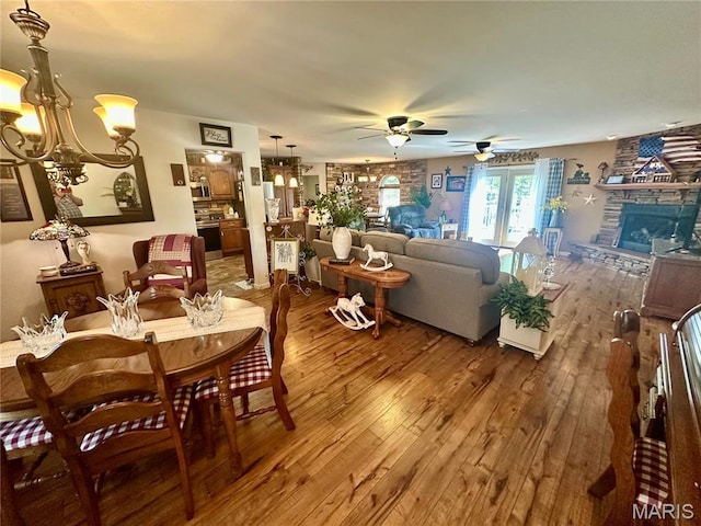 13 Montauk Ct, Leadington, MO 63601 - dining room with hardwood / wood-style floors, a chandelier, ceiling fan, and a stone fireplace