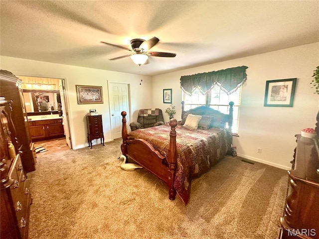 13 Montauk Ct, Leadington, MO 63601 - bedroom featuring light carpet, baseboards, connected bathroom, a textured ceiling, and ceiling fan