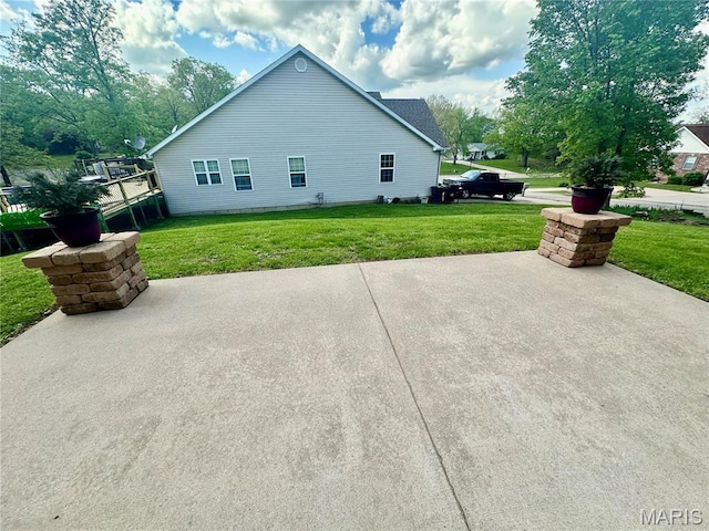 13 Montauk Ct, Leadington, MO 63601 - view of side of home featuring a patio and a yard
