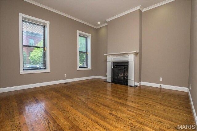 1703 Carroll St, Saint Louis, MO 63104 - unfurnished living room with wood finished floors, baseboards, crown molding, and a fireplace