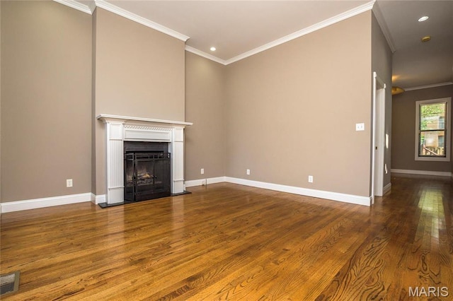 1703 Carroll St, Saint Louis, MO 63104 - unfurnished living room with dark wood-style flooring, crown molding, a fireplace with flush hearth, baseboards, and recessed lighting