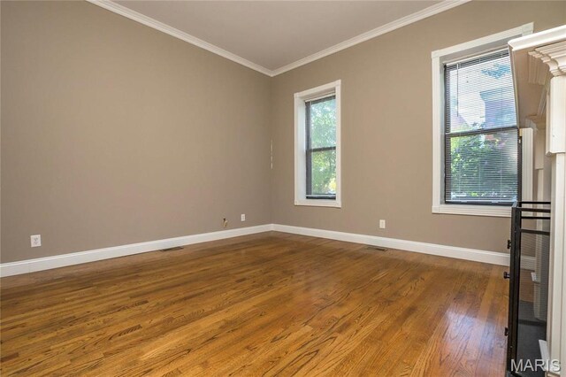 1703 Carroll St, Saint Louis, MO 63104 - spare room featuring ornamental molding, baseboards, and wood finished floors