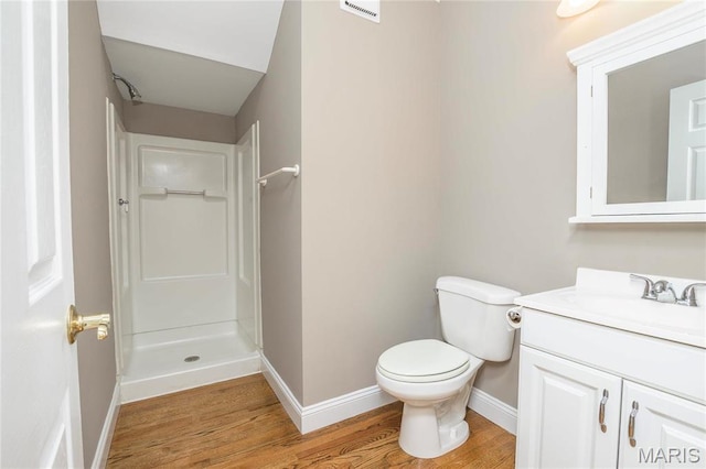 1703 Carroll St, Saint Louis, MO 63104 - bathroom featuring a stall shower, baseboards, wood finished floors, vanity, and toilet