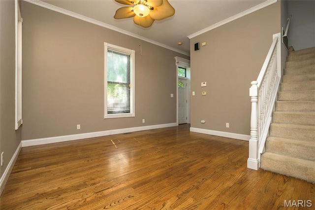 1703 Carroll St, Saint Louis, MO 63104 - spare room with ceiling fan, crown molding, wood finished floors, stairway, and baseboards
