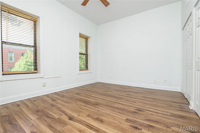 1703 Carroll St, Saint Louis, MO 63104 - unfurnished bedroom featuring wood finished floors, baseboards, a closet, and ceiling fan