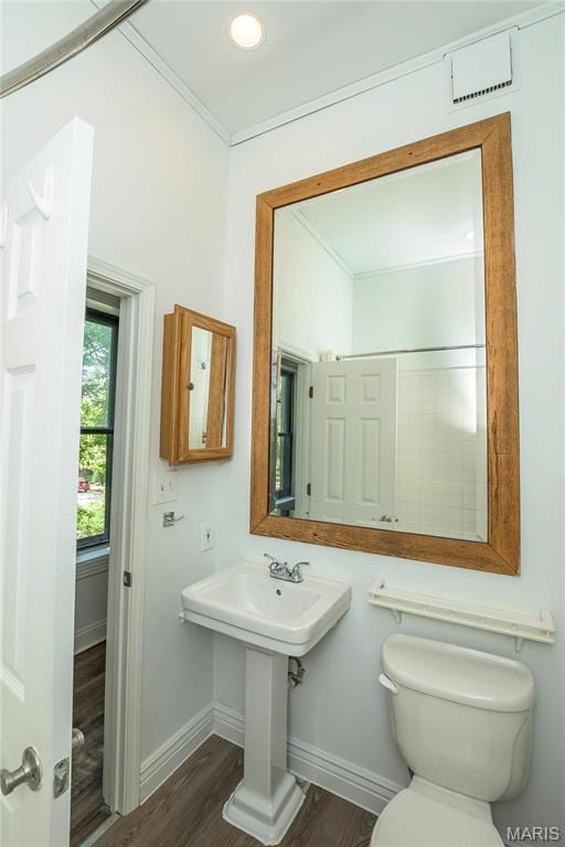 1703 Carroll St, Saint Louis, MO 63104 - half bath featuring baseboards, wood finished floors, toilet, and crown molding