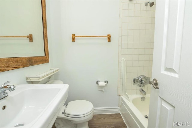 1703 Carroll St, Saint Louis, MO 63104 - bathroom with a sink, toilet, shower / bathtub combination, baseboards, and wood finished floors
