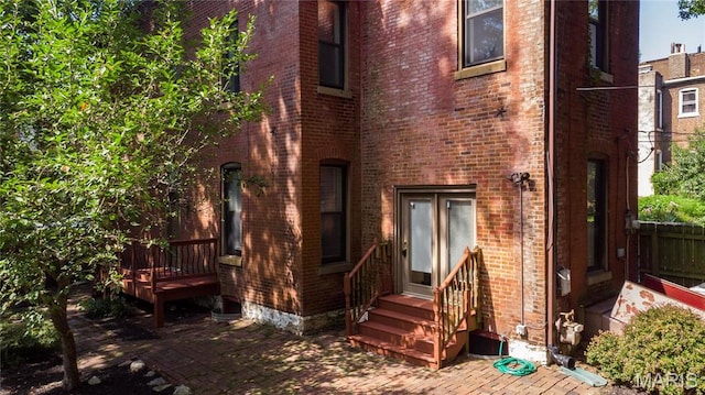 1703 Carroll St, Saint Louis, MO 63104 - rear view of house with brick siding, a patio, and a deck