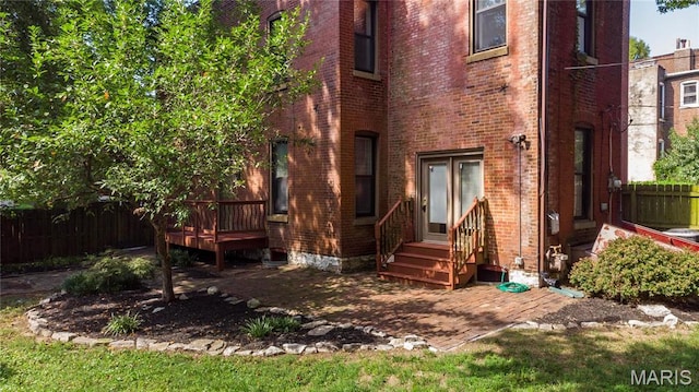 1703 Carroll St, Saint Louis, MO 63104 - rear view of house with fence, entry steps, brick siding, and a deck
