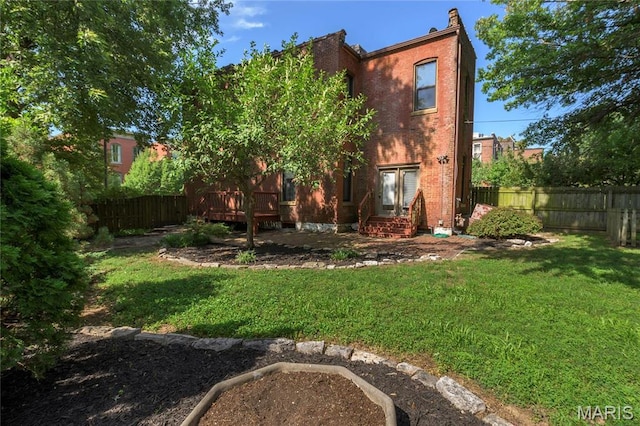 1703 Carroll St, Saint Louis, MO 63104 - rear view of house with a wooden deck and brick siding