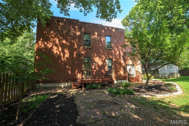 1703 Carroll St, Saint Louis, MO 63104 - back of house with fence, brick siding, a deck, and a patio