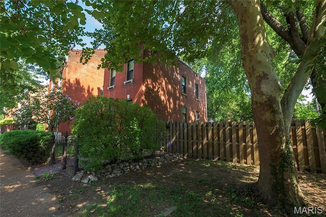 1703 Carroll St, Saint Louis, MO 63104 - view of side of home with fence and brick siding