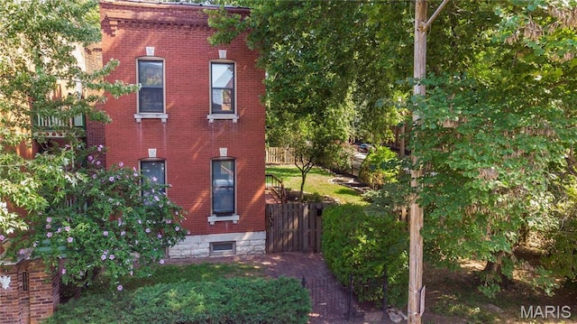 1703 Carroll St, Saint Louis, MO 63104 - view of side of home featuring brick siding and fence